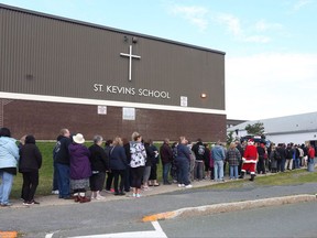 The lineup for tickets start early for the final draw of the Chase the Ace at St. Kevin's Parish Hall in Goulds, N.L. on Wednesday, August 30, 2017. A Catholic parish in St. John's, N.L., has the enviable task of deciding how to spend a $6 million windfall. THE CANADIAN PRESS/Paul Daly