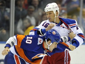 New York Rangers' Sean Avery (16) fights with New York Islanders' Mike Mottau (10) during the second period of an NHL hockey game on Tuesday, Nov. 15, 2011, in Uniondale, N.Y. Sean Avery on "Coach's Corner?"The former NHL bad boy says he could see himself dishing out opinions on today's hockey on TV. THE CANADIAN PRESS/AP, Kathy Kmonicek