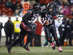 Calgary Stampeders quarterback Bo Levi Mitchell, right, hands off the ball to Jerome Messam during first half CFL football action against the Saskatchewan Roughriders in Calgary, Friday, Oct. 20, 2017. A division final already in their pockets, the Calgary Stampeders feel urgency to get their game in order for the playoffs. THE CANADIAN PRESS/Jeff McIntosh