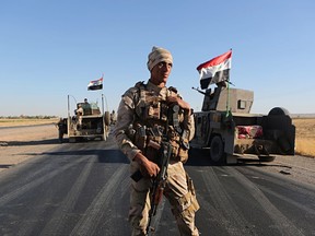 Iraqi security forces gather outside the Kurdish-held city of Altun Kupri on the outskirts of Irbil, Iraq on Oct. 19, 2017. A senior representative for Iraq's Kurdish government says Canada and its allies failed Iraq by ignoring the country's many political, religious and economic divisions while fighting the so-called Islamic State. THE CANADIAN PRESS/AP, Khalid Mohammed