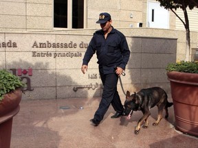 A K-9 security officer and his partner are deployed in front of the Canada embassy in Cairo, Egypt, which closed to the public on Monday, Dec. 8, 2014 over security concerns. Canada's foreign embassies and diplomatic outposts are getting new funds to bolster their security and some analysts say it is badly needed. THE CANADIAN PRESS/AP/Ahmed Abdel Fattah
