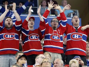 Fans of the Montreal Canadiens celebrate a goal by the team during the third period of its NHL hockey game against the Tampa Bay Lightning in Tampa, Fla., on Thursday, March 31, 2016. A new study suggests the excitement of watching one's favourite team can have a profound effect on the cardiovascular system by raising the heart rate. THE CANADIAN PRESS/AP-Mike Carlson