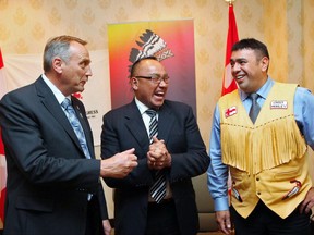 Grand Chief Ron Evans of the Assembly of Manitoba Chiefs, center, beams, as he, John Duncan, Minister of Indian Affairs and Northern Development, and Atlantic Policy Congress co-chair Chief Morley Googoo of Nova Scotia confer at a news conference in Halifax on Friday, October 1, 2010. Five Manitoba judges, including the chief justice of the Court of Queen's Bench, are scheduled to fly 500 kilometres north of Winnipeg Monday to meet with First Nations leaders and find ways to improve the justice system for Indigenous people. THE CANADIAN PRESS/ Tim Krochak