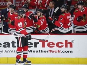 Chicago Blackhawks right wing Patrick Kane (88) celebrates with teammates after scoring against the Columbus Blue Jackets during the first period of an NHL hockey game Saturday, Oct. 7, 2017, in Chicago. (AP Photo/Kamil Krzaczynski)