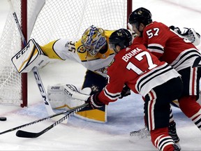 Nashville Predators goalie Pekka Rinne, left, blocks a shot against Chicago Blackhawks left wing Lance Bouma, left, and right wing Tommy Wingels during the first period of an NHL hockey game Saturday, Oct. 14, 2017, in Chicago. (AP Photo/Nam Y. Huh)