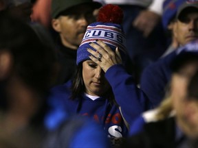 A Chicago Cubs fan reacts during the seventh inning of Game 3 of baseball's National League Championship Series against the Los Angeles Dodgers, Tuesday, Oct. 17, 2017, in Chicago. (AP Photo/Nam Y. Huh)