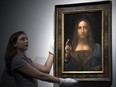 A member of staff poses with a painting by Leonardo da Vinci entitled 'Salvator Mundi' before it is auctioned in New York on Nov. 15, at Christie's. The painting is the last Da Vinci in private hands and is expected to fetch around US$100 million.