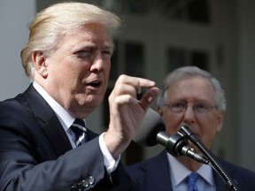 President Donald Trump answers questions as he speaks with Senate Majority Leader Mitch McConnell of Ky., in the rose Garden after their meeting at the White House, Monday, Oct. 16, 2017, in Washington. (AP Photo/Alex Brandon)