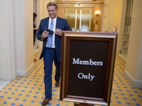 Sen. Jeff Flake, R-Ariz., walks on to the Senate floor on Capitol Hill in Washington, Tuesday, Oct. 24, 2017, after announcing he won't seek re-election in 2018. (AP Photo/Andrew Harnik)