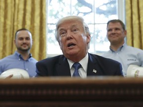 President Donald Trump speaks before signing a National Manufacturing Day Proclamation in the Oval Office of the White House in Washington, Friday, Oct. 6, 2017. (AP Photo/Carolyn Kaster)