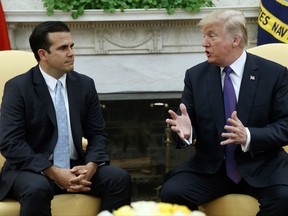 President Donald Trump meets with Governor Ricardo Rossello of Puerto Rico in the Oval Office of the White House, Thursday, Oct. 19, 2017, in Washington. (AP Photo/Evan Vucci)