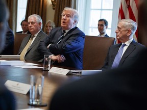 President Donald Trump speaks during a cabinet meeting at the White House, Monday, Oct. 16, 2017, in Washington, Secretary of State Rex Tillerson, left, and Secretary of Defense Jim Mattis, right, listen. (AP Photo/Evan Vucci)