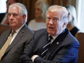 President Donald Trump speaks during a cabinet meeting at the White House, Monday, Oct. 16, 2017, in Washington, as Secretary of State Rex Tillerson listens. (AP Photo/Evan Vucci)