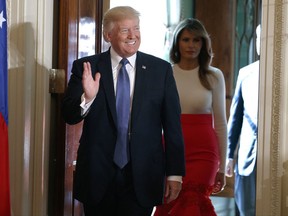 President Donald Trump waves as he and first lady Melania Trump arrive for a Hispanic Heritage Month event in the East Room of the White House, Friday, Oct. 6, 2017, in Washington. (AP Photo/Evan Vucci)