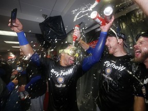 Members of the Chicago Cubs celebrate after Game 5 of baseball's National League Division Series against the Washington Nationals, at Nationals Park, Friday, Oct. 13, 2017, in Washington. The Cubs won 9-8. (AP Photo/Alex Brandon)