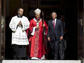 Cardinal Donald Wuerl, Archbishop of Washington, speaks with U.S. Supreme Court Chief Justice John Roberts as they leave St. Mathews Cathedral after the Red Mass in Washington on Sunday, Oct. 1, 2017. The Supreme Court's new term starts Monday, Oct. 2. (AP Photo/Jose Luis Magana)