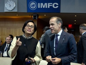 Indonesian Finance Minister Sri Mulyani Indrawati speaks with Bank of England Governor Mark Carney as they attend the International Monetary and Financial Committee (IMFC) conference at World Bank/IMF Annual Meetings in Washington, Saturday, Oct. 14, 2017. ( AP Photo/Jose Luis Magana)