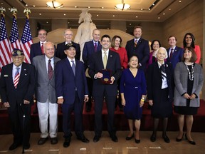 Speaker of the House Paul Ryan of Wis., presents the Congressional Gold Medal to Filipino veterans of World War II and their next of kin, from left, Celestino Almeda, Frank Francone, Aquilino Delen, Ryan, Alicia Benitez, Margrit Baltazar and Caroline Burkhart, during a ceremony at the Emancipation Hall on Capitol Hill in Washington, Wednesday, Oct. 25, 2017. Standing with the recipients are, from left back row, Veterans Affairs Secretary David Shulkin, Senate Majority Leader Mitch McConnell of Ky., Senate Minority Leader Chuck Schumer of New York, House Minority Leader Nancy Pelosi of Calif., Sen. Dean Heller, R-Nev., Sen. Mazie Hirono, D-Hi., Rep. Ed Royce, R-Calif., and Rep. Tulsi Gabbard, D-Hi. (AP Photo/Manuel Balce Ceneta)