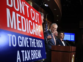 Senate Minority Leader Chuck Schumer of New York, with House Minority Leader Nancy Pelosi of Calif., right, and Sen. Bernie Sanders, I-Vt., back second from right, speaks during a news conference on Capitol Hill in Washington, Wednesday, Oct. 4, urging Republicans to abandon cuts to Medicare and Medicaid. (AP Photo/Manuel Balce Ceneta)