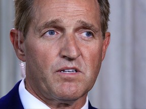 Sen. Jeff Flake, R-Ariz., speaks during a television interview Capitol Hill in Washington, Tuesday, Oct. 24, 2017. Sen. Flake, an Arizona Republican, announced he would not run for re-election in 2018, condemning in a speech aimed at President Donald Trump the "flagrant disregard of truth and decency" that is undermining American democracy. (AP Photo/Manuel Balce Ceneta)