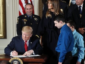 President Donald Trump signs a  presidential memorandum declaring the opioid crisis a public health emergency in the East Room of the White House, Thursday, Oct. 26, 2017, in Washington. (AP Photo/Pablo Martinez Monsivais)