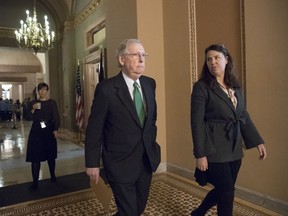 Senate Majority Leader Mitch McConnell, R-Ky., joined at right by Secretary for the Majority Laura Dove, walks from his office to the chamber for the start of the legislative day, at the Capitol in Washington, Tuesday, Oct. 17, 2017.  (AP Photo/J. Scott Applewhite)