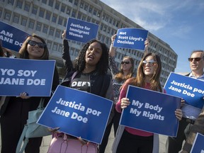 Activists with Planned Parenthood demonstrate in support of a pregnant 17-year-old being held in a Texas facility for unaccompanied immigrant children to obtain an abortion, outside of the Department of Health and Human Services in Washington, Friday, Oct. 20, 2017. (AP Photo/J. Scott Applewhite)