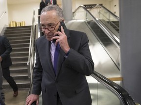 Senate Minority Leader Chuck Schumer, D-N.Y., makes a call as senators arrive for votes at the Capitol in Washington, Thursday, Oct. 19, 2017. (AP Photo/J. Scott Applewhite)