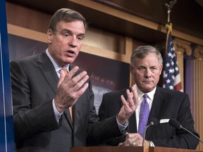 Senate Select Committee on Intelligence Vice Chairman Mark Warner, D-Va., left, joined by Chairman Richard Burr, R-N.C., updates reporters on the status of their inquiry into Russian interference in the 2016 U.S. elections, at the Capitol in Washington, Wednesday, Oct. 4, 2017. Burr says the committee has interviewed more than 100 witnesses as part of its investigation and that more work still needs to be done. (AP Photo/J. Scott Applewhite)