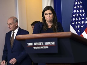 White House Chief of Staff John Kelly, left, arrives with White House press secretary Sarah Huckabee Sanders for the daily press briefing at the White House in Washington, Thursday, Oct. 12, 2017. (AP Photo/Susan Walsh)