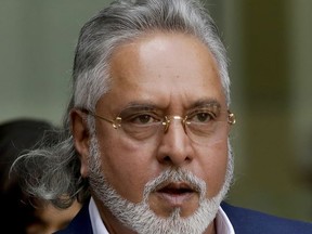FILE - In this June 13, 2017 file photo, former Indian politician and billionaire businessman Vijay Mallya leaves after his extradition hearing arrives at Westminster Magistrates Court in London. The Indian government has brought a new money-laundering charge against the prominent Indian tycoon who is fighting extradition from Britain. Britain's Crown Prosecution Service said Mallya appeared in court Tuesday, Oct. 3, and was released on bail. He is due back in court on Dec. 4 for an extradition hearing expected to last eight days. (AP Photo/Matt Dunham, File)