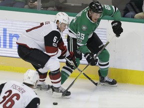 Arizona Coyotes left wing Lawson Crouse (67) and Dallas Stars right wing Brett Ritchie (25) skate for control of the puck during the first period of an NHL hockey game in Dallas, Tuesday, Oct. 17, 2017. (AP Photo/LM Otero)