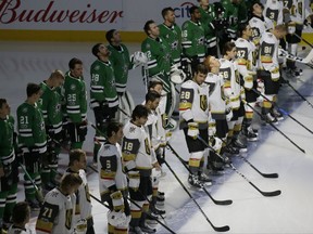 The Dallas Stars and Vegas Golden Knights line up for a moment of silence for shooting victims in Las Vegas before an NHL hockey game in Dallas, Friday, Oct. 6, 2017. (AP Photo/LM Otero)