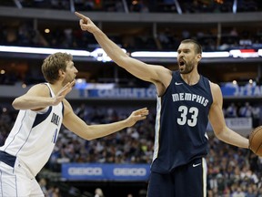 Dallas Mavericks' Dirk Nowitzki (41) of Germany defends as Memphis Grizzlies' Marc Gasol (33) directs the offense in the first half of an NBA basketball game, Wednesday, Oct. 25, 2017, in Dallas. (AP Photo/Tony Gutierrez)