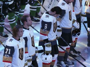 Vegas Golden Knights defenceman Colin Miller (6) bows his head as he lines up with teammates and the Dallas Stars for a moment of silence for Las Vegas shooting victims on Oct. 6.