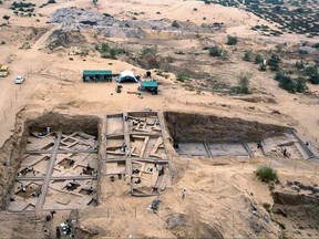 In this undated image taken in 2000, provided by the Palestinian Department of Antiquities, an aerial view of the excavations at Tel Es-Sakan, shows houses dating to 2600-2300 B.C., left, and fortifications from the late fourth millennium B.C, south of Gaza City. Palestinian and French archaeologists began excavating Gaza's earliest archaeological site nearly 20 years ago; unearthing what they believe is a rare 4,500-year-old Bronze Age settlement. But over protests that grew recently, Gaza's Hamas rulers have systematically destroyed the work since seizing power a decade ago, to make way for construction projects, and later military bases. (Pierre de Miroschedji/Palestinian Department of Antiquities, via AP)