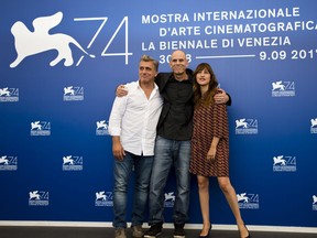 File - In this Saturday, Sept. 2, 2017 file photo, Director Samuel Maoz, center, and actors Lior Ashkenazi, left, and Sarah Adler pose during the photo call for the film "Foxtrot" at the 74th Venice Film Festival in Venice, Italy. "Foxtrot", a drama exploring the occupation of the West Bank, and Israel's contender for this year's foreign language Oscar has received a rockier reception at home, where it is caught in the crossfire of Israel's culture war. (AP Photo/Domenico Stinellis, File)