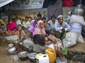 Rohingya Muslims, who crossed over from Myanmar into Bangladesh, rest inside a school compound at Kutupalong refugee camp, Bangladesh, Monday, Oct. 23, 2017. Nearly 600,000 Rohingya Muslims have fled Myanmar's Rakhine state and arrived in Bangladesh since Aug. 25 to avoid persecution that the United Nations has called ethnic cleansing. (AP Photo/Dar Yasin)