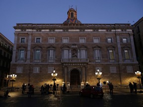 TV crews stand in front of the Palau Generalitat as they wait for the arrival of the Catalonia president Carles Puigdemont, in Barcelona, Spain, early Monday Oct. 30, 2017. Hundreds of thousands of Catalans took to the streets of Barcelona Sunday to call for their region to remain part of Spain, two days after regional lawmakers exacerbated a political crisis by voting for the wealthy region to secede. (AP Photo/Manu Fernandez)