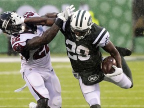 New York Jets' Bilal Powell (29) stiff-arms Atlanta Falcons' Keanu Neal (22) during the first half of an NFL football game, Sunday, Oct. 29, 2017, in East Rutherford, N.J. (AP Photo/Bill Kostroun)