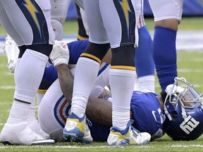 New York Giants wide receiver Odell Beckham grabs his leg after suffering an injury during the second half of an NFL football game against the Los Angeles Chargers, Sunday, Oct. 8, 2017, in East Rutherford, N.J. The Chargers won 27-22. (AP Photo/Bill Kostroun)
