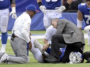 New York Giants wide receiver Odell Beckham holds his leg after suffering an injury during the second half of an NFL football game against the Los Angeles Chargers, Sunday, Oct. 8, 2017, in East Rutherford, N.J. (AP Photo/Bill Kostroun)