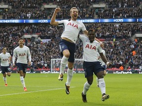 Tottenham's Harry Kane, center, celebrates after scoring his side's first goal during the English Premier League soccer match between Tottenham Hotspur and Liverpool at Wembley Stadium in London, Sunday, Oct. 22, 2017. (AP Photo/Frank Augstein)