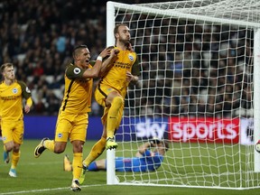 Brighton's Glenn Murray , center, celebrates after scoring his side's third goal during the English Premier League soccer match between West Ham and Brighton and Hove Albion at London Stadium in London, Friday, Oct. 20, 2017.(AP Photo/Kirsty Wigglesworth)
