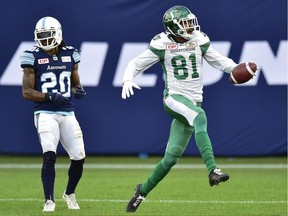 Toronto Argonauts linebacker Rico Murray (left) looks on as Saskatchewan Roughriders wide receiver Bakari Grant celebrates a touchdown on Oct. 7.