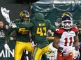 Edmonton Eskimos receiver Adarius Bowman (left) and defensive end Odell Willis celebrate a touchdown against the Calgary Stampeders on Oct. 28.