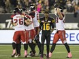 Hamilton Tiger-Cats wide receiver Brandon Banks (16) walks away in defeat as the Calgary Stampeders celebrate their game-winning field goal with no time left on the clock on Oct. 13.