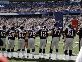 Members of the New England Patriots stand along the sideline during the national anthem before an NFL football game against the Carolina Panthers, Sunday, Oct. 1, 2017, in Foxborough, Mass. (AP Photo/Charles Krupa)