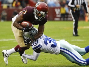 Washington Redskins wide receiver Jamison Crowder (80) is stopped by Dallas Cowboys cornerback Anthony Brown (30) during the first half of an NFL football game in Landover, Md., Sunday, Oct. 29, 2017. (AP Photo/Patrick Semansky)