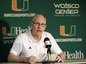 Miami NCAA college basketball head coach Jim Larranaga reads a statement to reporters during a news conference, Monday, Oct. 23, 2017, in Coral Gables, Fla. Miami has been linked to the federal investigation into corruption of college basketball that has rocked the sport, and Larranaga discussed allegations that someone was willing to pay $150,000 to get a recruit to commit to the Hurricanes. Larranaga, through his attorney, has denied any involvement. (AP Photo/Alan Diaz)